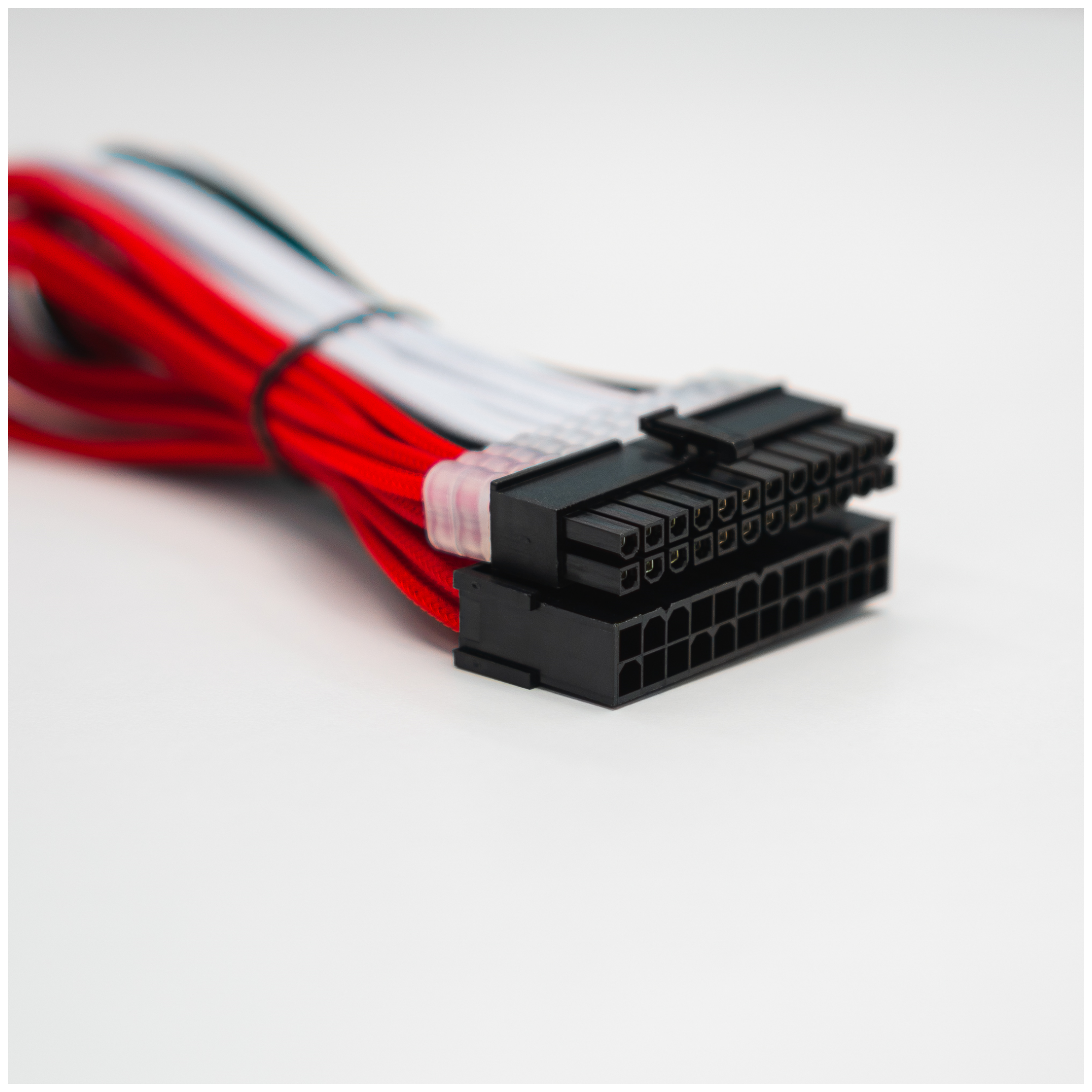 A large main feature product image of GamerChief Elite Series 24-Pin ATX 30cm Sleeved Extension Cable (Red/White/Black)