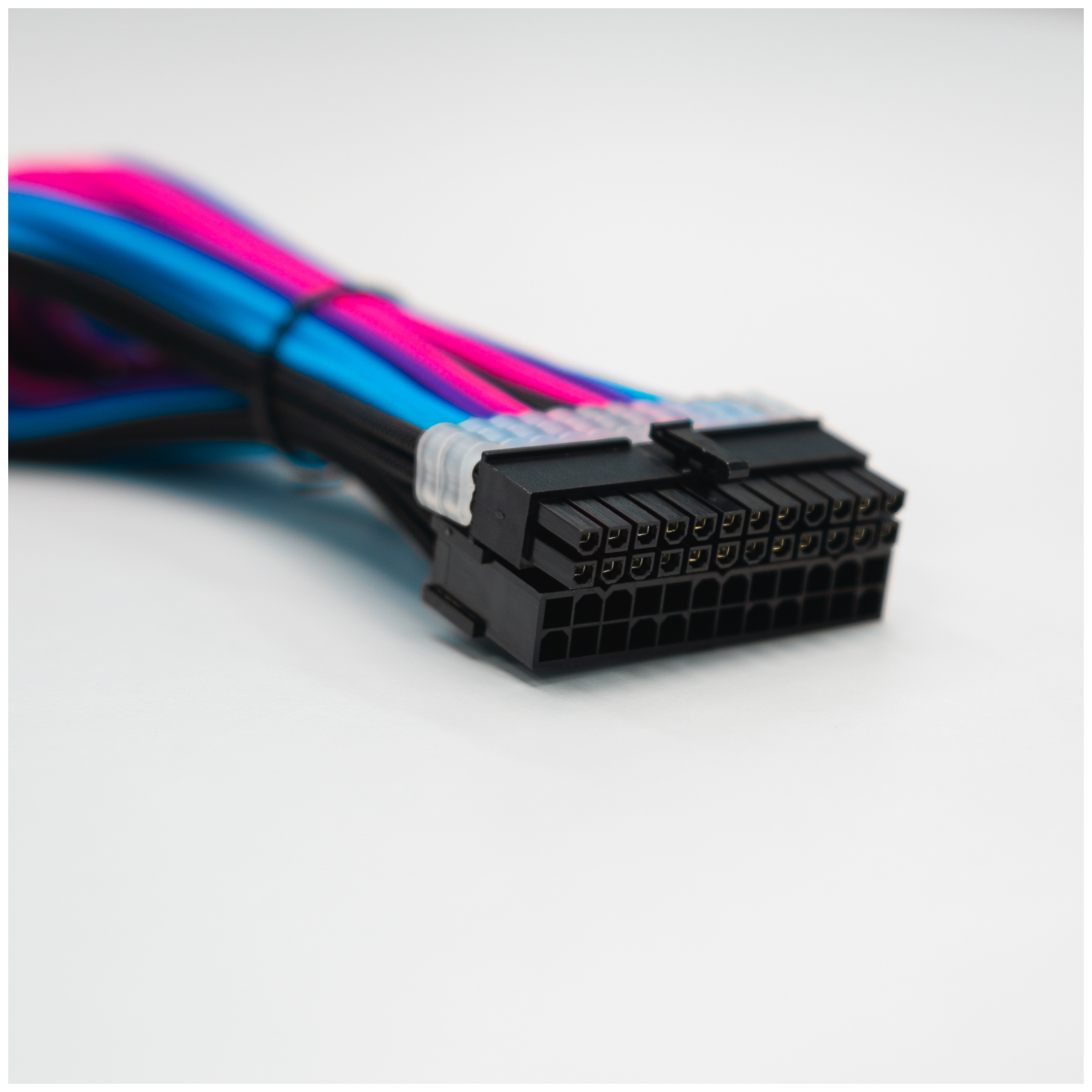 A large main feature product image of GamerChief Elite Series 24-Pin ATX 30cm Sleeved Extension Cable (Blue/Pink/Purple/Black)