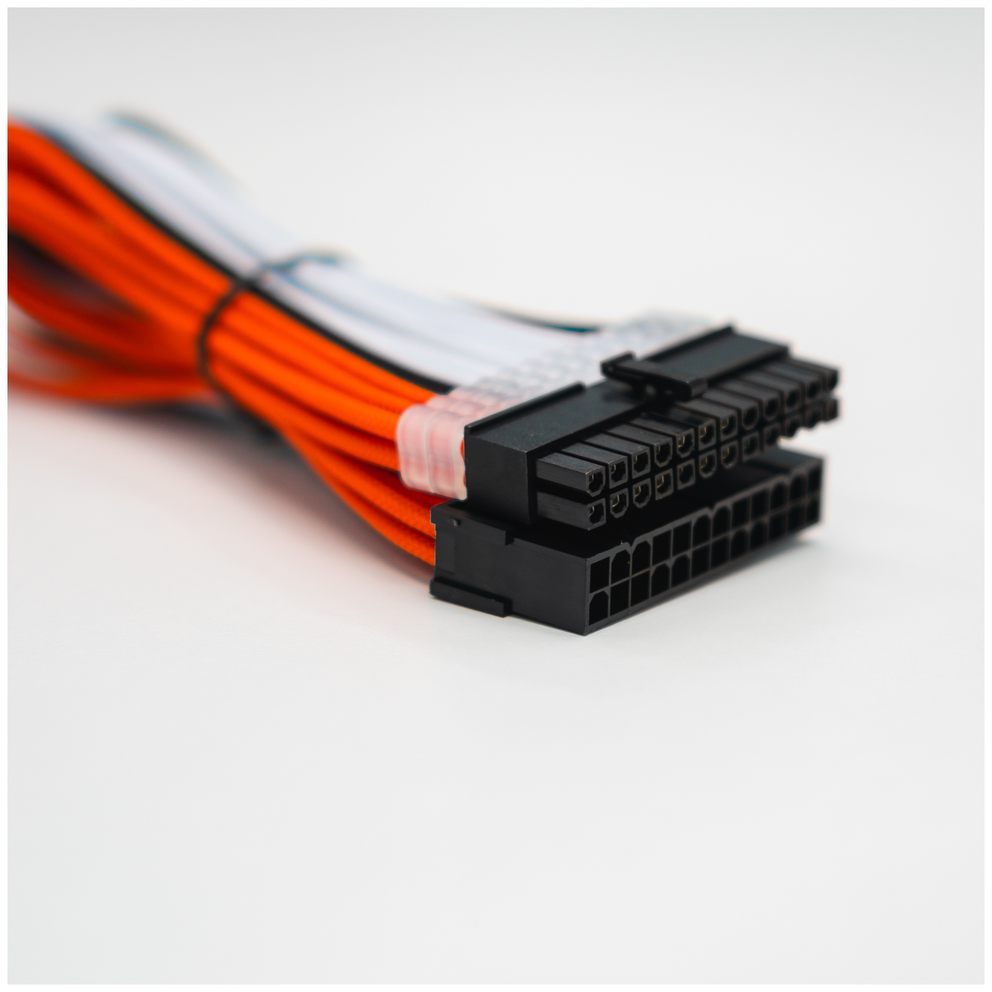 A large main feature product image of GamerChief Elite Series 24-Pin ATX 30cm Sleeved Extension Cable (Orange/White/Black)